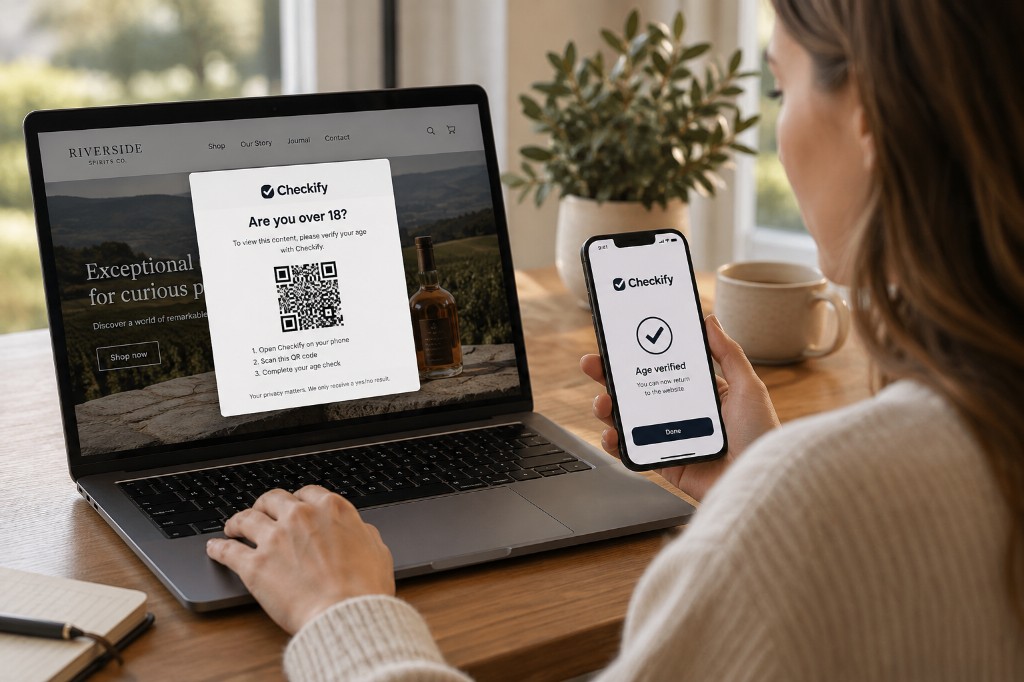 Person verifying age on their phone while a website age check with a Checkify QR code is open on their laptop